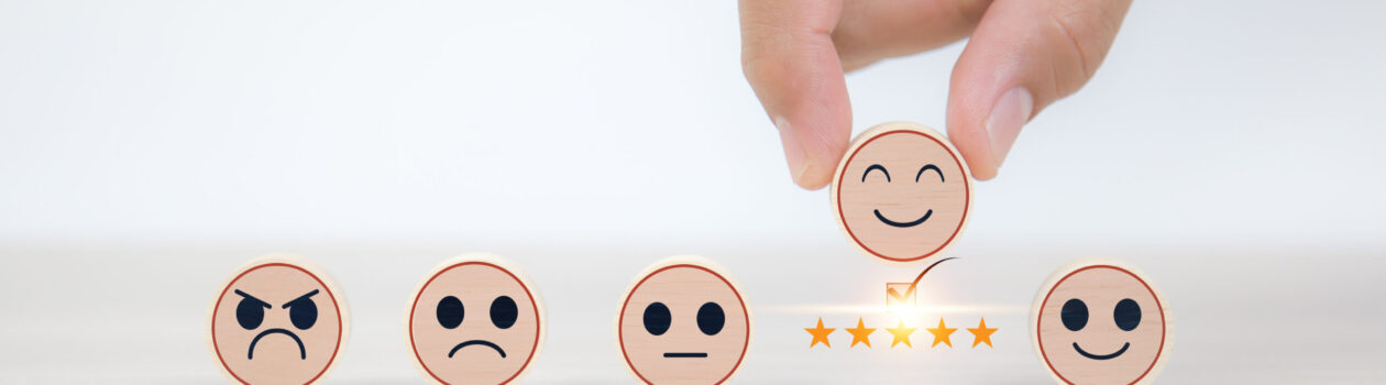 Smiley face on wooden toy for customer services rating feedback