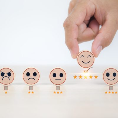 Smiley face on wooden toy for customer services rating feedback